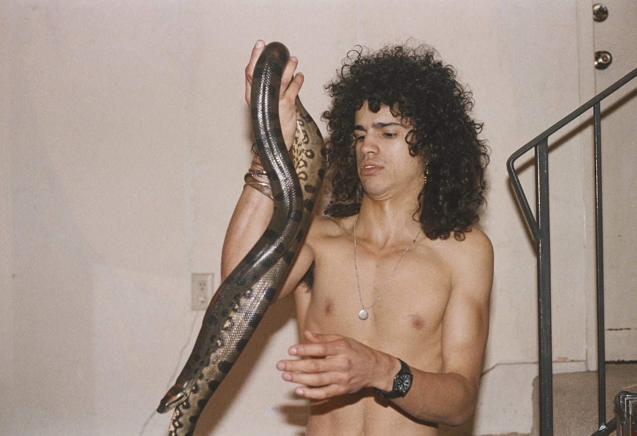 default-591 Shirtless man holding snake.